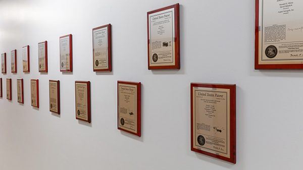 white wall with hung aspen aerogels patent plaques